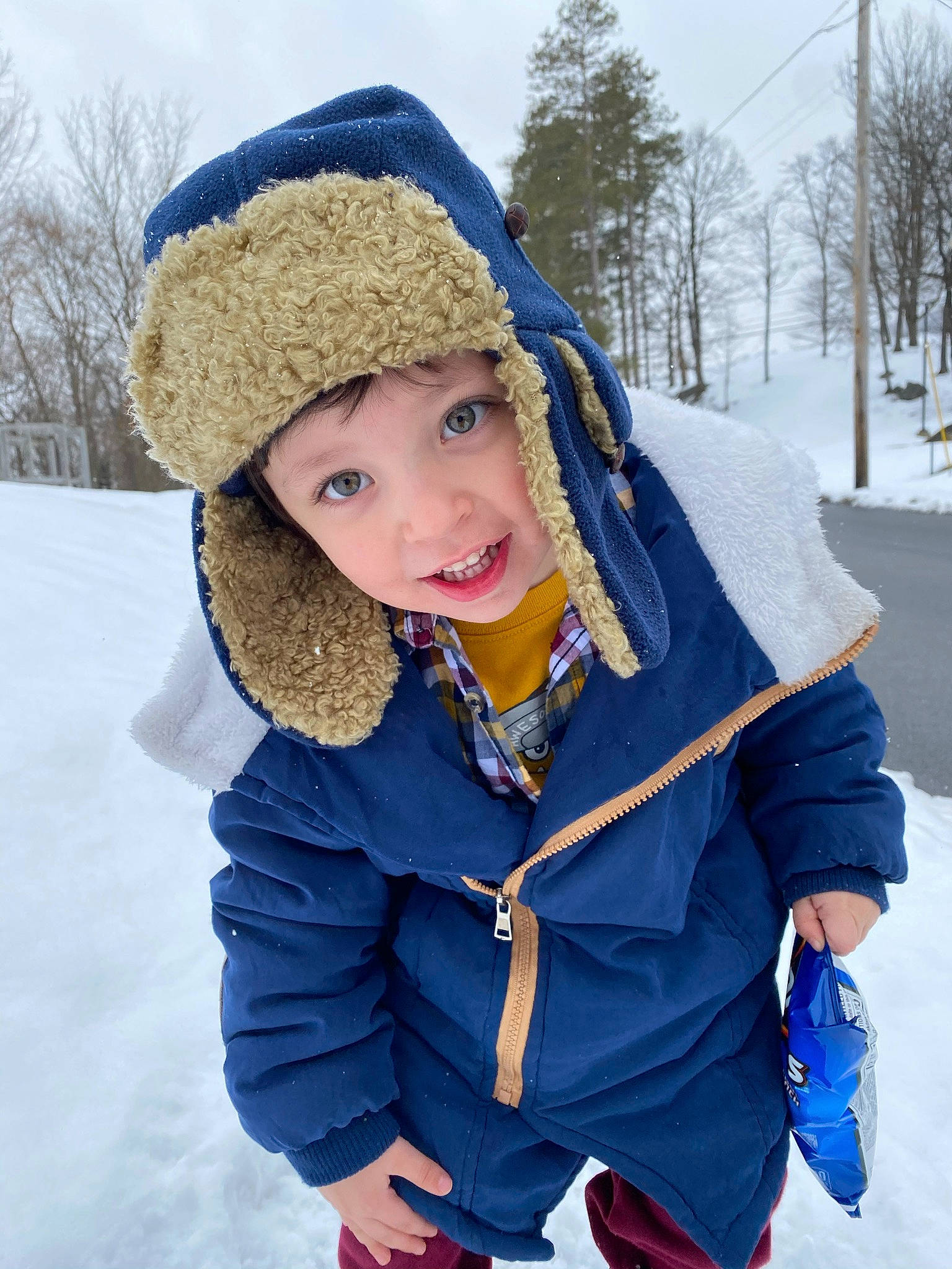 Benji is registered to the contest to win money with this photo: beauty, cap, cool, freezing, fun, glove, happy, headgear, headwear, jacket, knit_cap, leisure, outerwear, person, recreation, sky, smile, snow, street_fashion, toddler