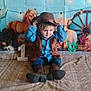 child, baby, cowboy, hat, vest, boots, blanket, birthday, number_one, western_theme, horses, wagon_wheel, cactus, decorations, indoor, portrait, cute, celebration, smiling, sitting