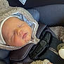 baby, sleeping, car_seat, jacket, hat, pacifier, child, infant, straps, cozy, cute, face, hand, seatbelt, safety, closeup, indoor, wearing, resting, peaceful