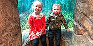 Aubrey is registered to the contest to win money with this photo: child, children, aquarium, fish, underwater, rocks, cave, smile, girl, boy, pacifier, jacket, dress, shoes, sitting, glass, water, tank, nature, playful