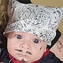 baby, bandana, face_paint, mustache, goatee, blue_eyes, curly_hair, tattoo, red_clothing, black_clothing, portrait, indoor, person, cute, infant, headwear, expression, closeup, human, child