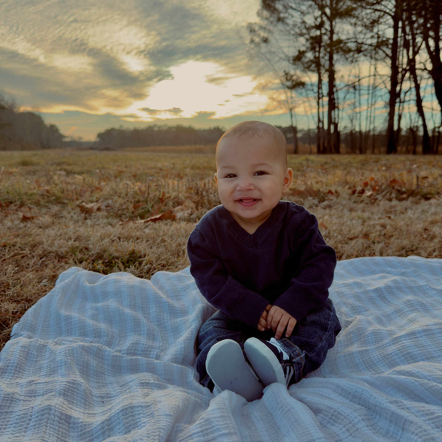 Suede is registered to the contest to win money with this photo: baby, blanket, clouds, cute, denim, field, grass, happy, infant, nature, outdoor, portrait, shoes, sitting, sky, smile, sunset, sweater, toddler, trees