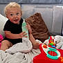 Hyland Rush joined the competition — help win amazing prizes! baby, blanket, bottle, child, comfort, couch, curly_hair, cute, guitar, happy, indoors, living_room, person, pillow, playtime, smiling, soft_toys, toddler, toy, young_child