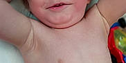 Hyland Rush is registered to the contest to win money with this photo: arm, baby, bare_chest, blanket, blond_hair, child, cute, face, hand, happy, indoor, lying_down, pink, playtime, relaxed, skin, smiling, toddler, toy, white