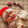 Ella participe au concours pour gagner de l'argent avec cette photo : baby, smiling, hat, knit_hat, gingerbread_man, sweater, holiday, christmas, cookie, decorations, rug, cozy, festive, cute, child, face, happy, indoors, warm, portrait