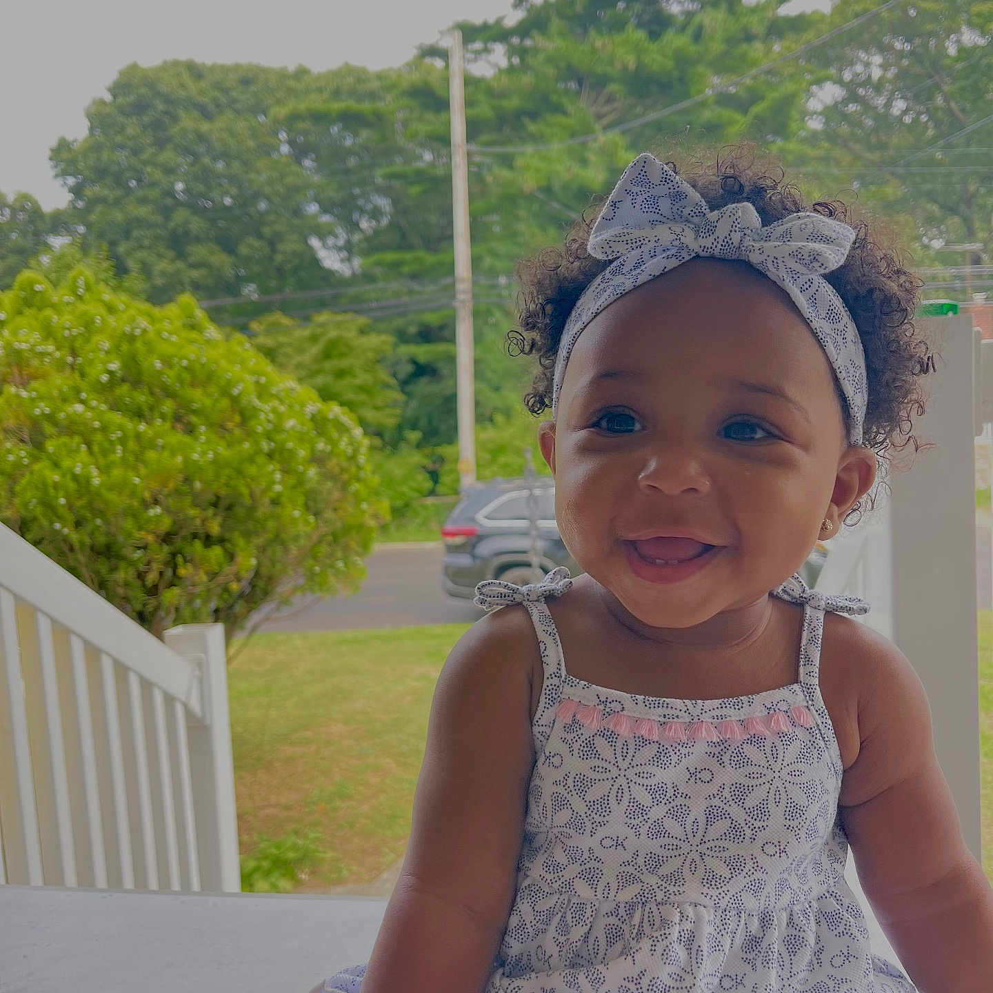Ahlani joined the competition — help win amazing prizes! accessories, baby, backyard, cap, clothing, dress, face, fence, grass, happy, hat, head, outdoors, person, photography, plant, portrait, smile, summer, tree