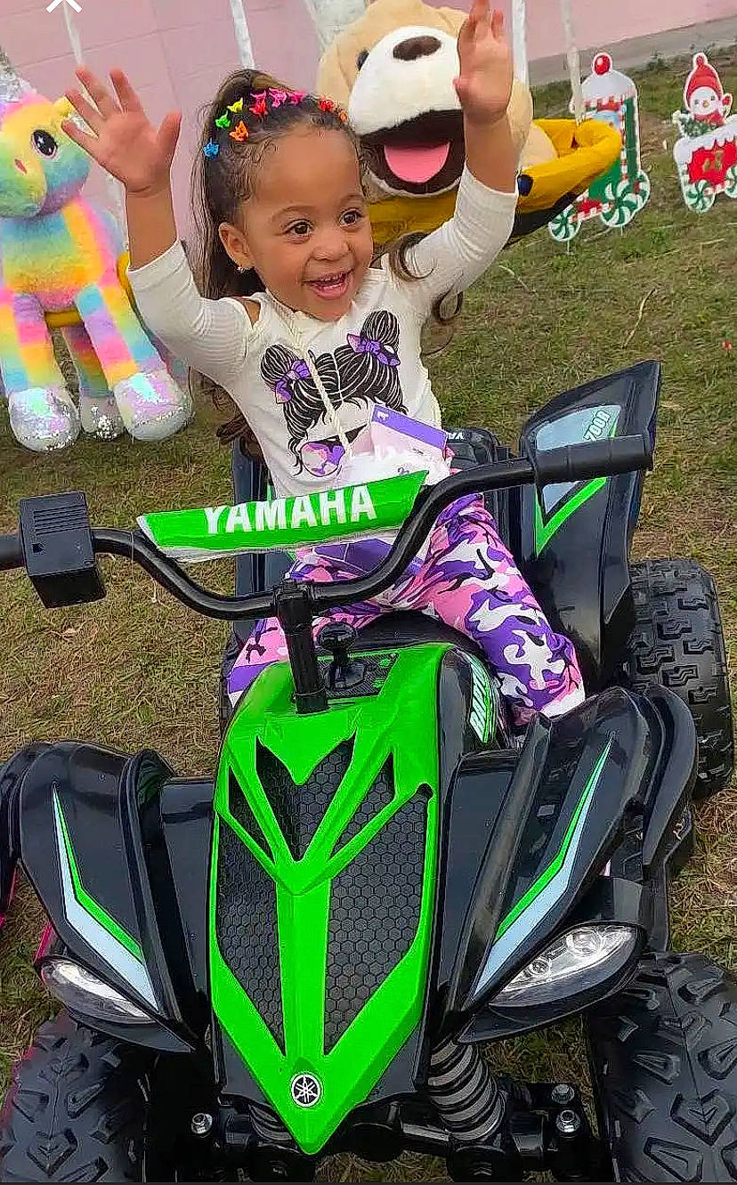 Alianys is registered to the contest to win money with this photo: automotive_design, automotive_exterior, automotive_tire, fun, green, happy, joy, light, motor_vehicle, motorsport, person, photograph, pink, purple, rim, smile, snapshot, tire, toddler, vehicle
