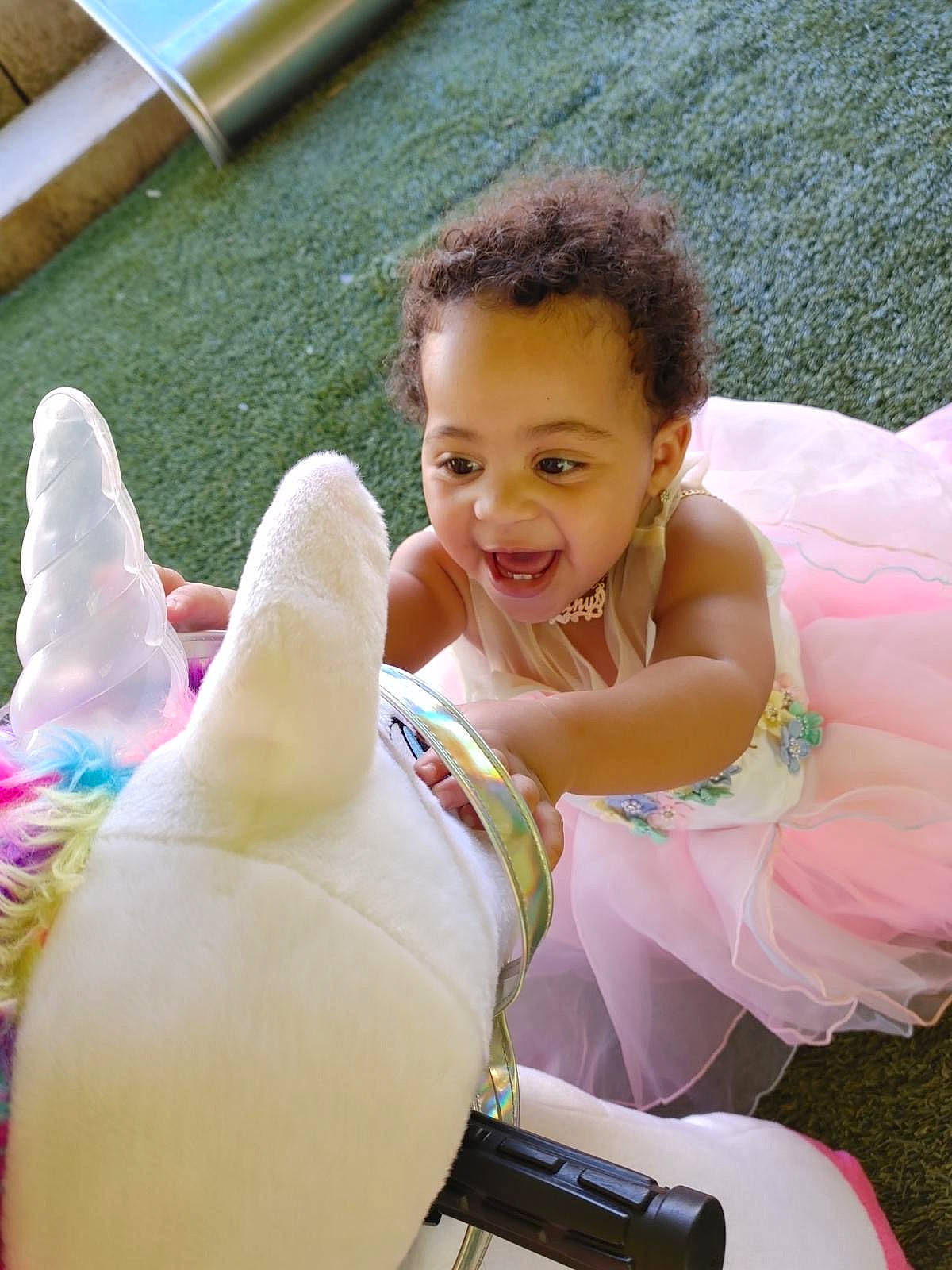 Alianys joined the competition — help win amazing prizes! chest, child, comfort, face, facial_expression, fun, gesture, grass, happy, human_leg, lap, leisure, person, pink, recreation, sitting, skin, smile, thigh, toddler