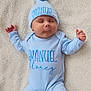 baby, sleeping, blue_clothing, hat, onesie, blanket, infant, soft_texture, peaceful, cute, newborn, foot, hand, portrait, child, resting, cozy, indoors, fabric, person