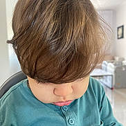 Amir a rejoint le concours — aidez-le/la à gagner de superbes lots ! toddler, child, hair, brown_hair, looking_down, blue_shirt, buttoned_shirt, indoor, home, portrait, young_child, face, curly_hair, casual_clothing, childhood, person, cute, soft_light, closeup, contemplative