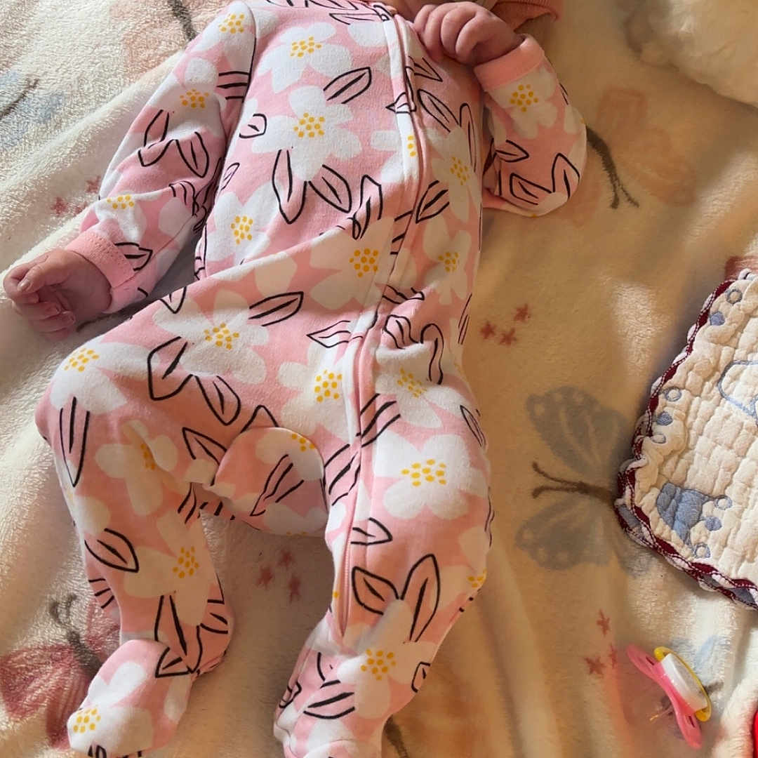 Avery is registered to the contest to win money with this photo: baby, blanket, butterfly_pattern, child, clothing, cozy, cute, floral_pattern, headband, indoor, infant, lying_down, newborn, onesie, pacifier, peaceful, pink, resting, sleepwear, soft_toys