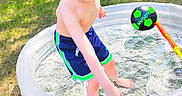 Niklaus joined the competition — help win amazing prizes! child, boy, pool, inflatable_pool, water, smiling, outdoor, grass, sunlight, hose, summer, play, barefoot, shorts, toy, ball, fence, trees, happy, recreation