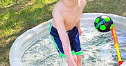Niklaus joined the competition — help win amazing prizes! backyard, ball, boy, child, fun, grass, happy, hose, inflatable_pool, outdoor, play, pool, recreation, shorts, smiling, summer, sunlight, toy, trees, water