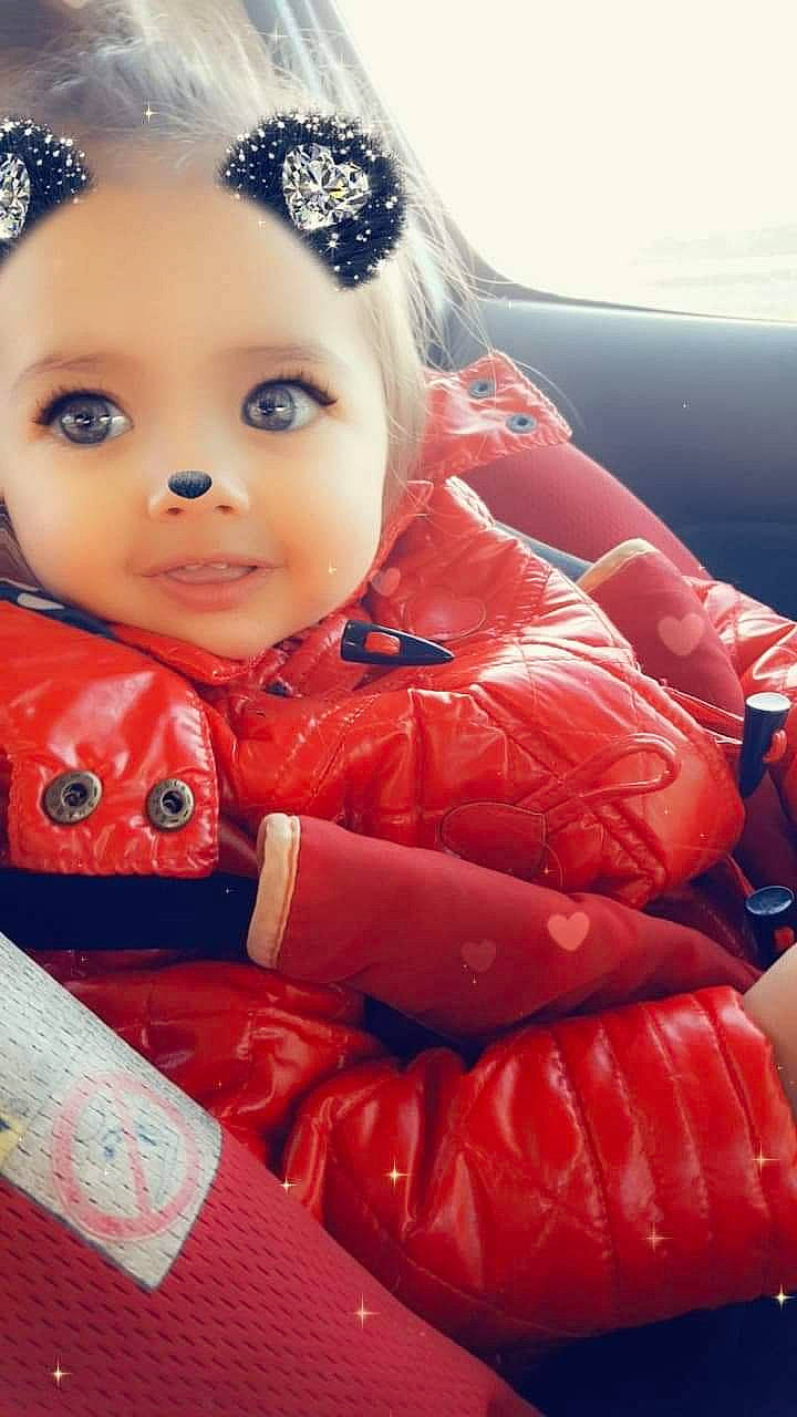 Amélie participe au concours pour gagner de l'argent avec cette photo : baby, black_hair, cheek, child, eye, lip, mouth, outerwear, peach, person, plant, red, skin, toddler