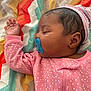 Lamauri Coleman is registered to the contest to win money with this photo: baby, blanket, child, colorful, cute, ear, face, hand, headwear, indoor, infant, pacifier, peaceful, pink_onesie, polka_dots, portrait, rest, sleep, sleeping, zigzag_pattern