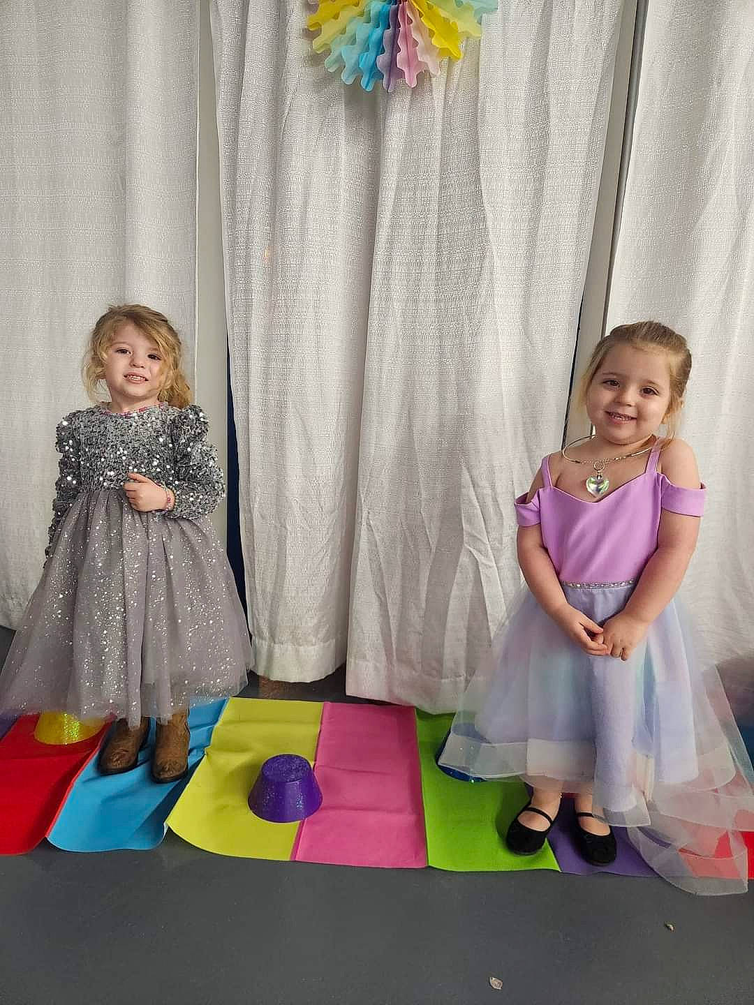 Layla is registered to the contest to win money with this photo: baby_toddler_clothing, child, curtain, dress, event, fashion_design, flooring, fun, happy, joy, magenta, pattern, person, pink, play, purple, room, smile, textile, toddler