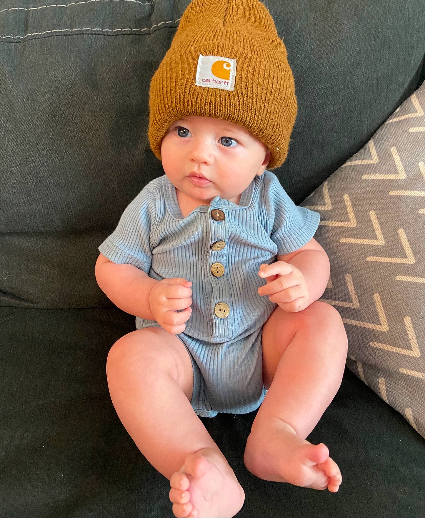 Bentley joined the competition — help win amazing prizes! baby, baby_toddler_clothing, barefoot, cap, child, comfort, dress, face, facial_expression, foot, headgear, headwear, human_body, human_leg, knee, lap, outerwear, person, skin, sleeve