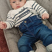 Matteo a rejoint le concours — aidez-le/la à gagner de superbes lots ! baby, infant, child, sweater, striped_clothing, jeans, socks, pacifier, baby_seat, cushion, carpet, indoor, portrait, clothing, casual, cute, person, young_child, resting, comfortable