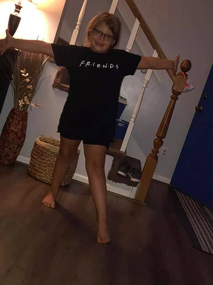 Kinsey is registered to the contest to win money with this photo: balance, blond, calf, event, fashion_design, flash_photography, floor, flooring, foot, hardwood, human_leg, joint, joy, knee, person, sandal, sleeve, smile, stairs, thigh