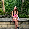 woman, baby, smiling, outdoor, bench, greenery, plants, leafy_background, casual_clothing, sneakers, happy, portrait, nature, daylight, person, child, mother_and_child, sitting, family, cute