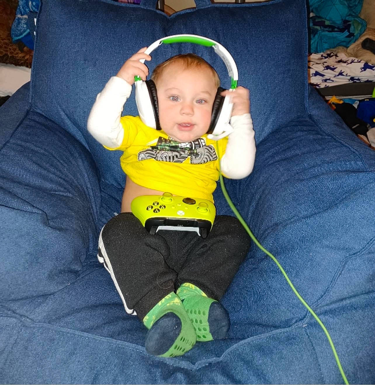 Buddy is registered to the contest to win money with this photo: baby, baby_products, baby_safety, baby_toddler_clothing, chair, child, comfort, electric_blue, face, finger, fun, furniture, grass, head, leg, person, personal_protective_equipment, play, sitting, t_shirt