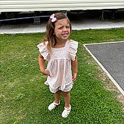 Aria joined the competition — help win amazing prizes! child, girl, grass, outdoor, dress, pink_bow, sandals, sidewalk, mobile_home, lawn, summer, standing, cute, person, expression, greenery, footwear, hair_accessory, sunlight, portrait