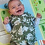 Elyam participe au concours pour gagner de l'argent avec cette photo : baby, child, smiling, happy, play_mat, green_shirt, patterned_clothing, infant, cute, portrait, lying_down, indoor, cheerful, buttoned_shirt, toddler, hands, face, teeth, clothing, colorful