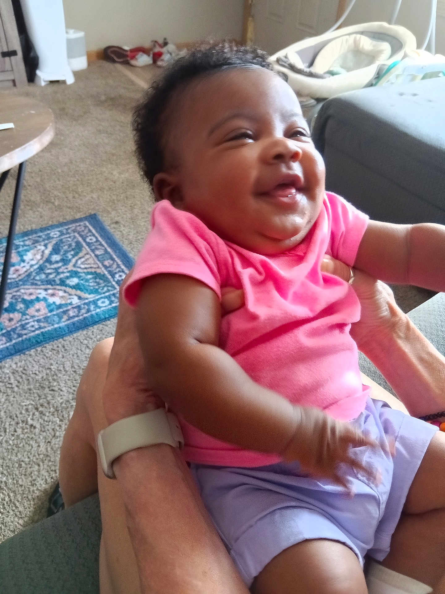 Xamira joined the competition — help win amazing prizes! baby, child, smiling, pink_shirt, purple_shorts, indoor, carpet, furniture, person, happy, hands, living_room, baby_gear, cute, infant, portrait, sitting, skin, closeup, human