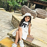 Ariza joined the competition — help win amazing prizes! child, girl, white_dress, hat, sneakers, smile, outdoor, garden, stone_steps, wicker_furniture, greenery, patio, casual, cute, young, person, daylight, relaxed, fashion, happy