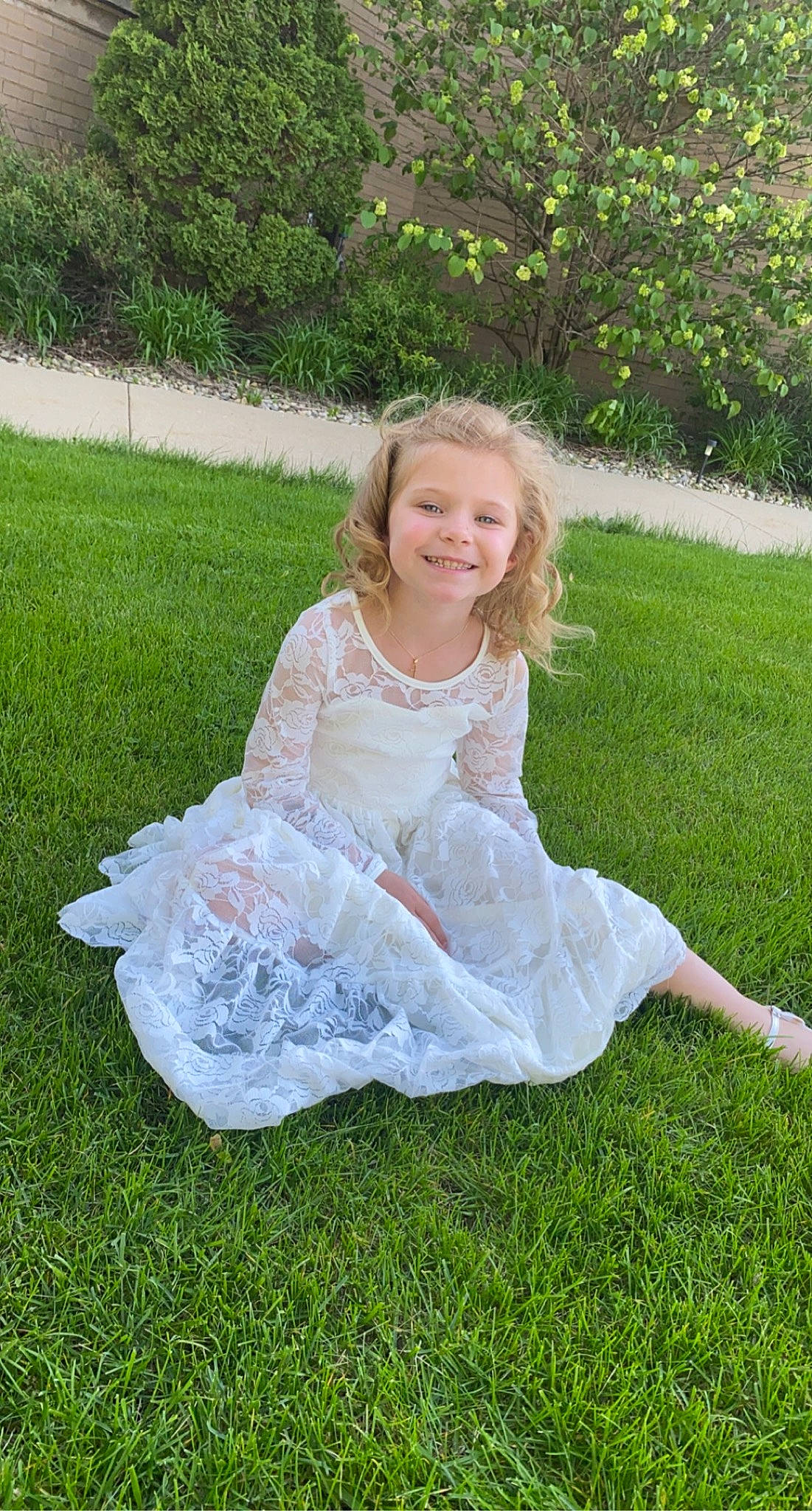 Sophia is registered to the contest to win money with this photo: arm, baby_toddler_clothing, day_dress, dress, embellishment, eye, face, flash_photography, grass, hair, happy, head, human_body, joy, lawn, meadow, people_in_nature, person, plant, smile