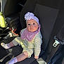 baby, infant, child, flower_headband, headband, pink_bib, knit_outfit, socks, car_seat, car_interior, seat_belt, buckle, portrait, looking_up, big_eyes, cute, sitting, sunlight, hand, seat
