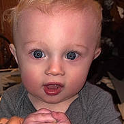 Atreus is registered to the contest to win money with this photo: baby, child, infant, blue_eyes, curly_hair, holding_hands, gray_clothing, indoor, close_up, person, cute, young_child, skin, face, expression, hand, portrait, toddler, human, curious