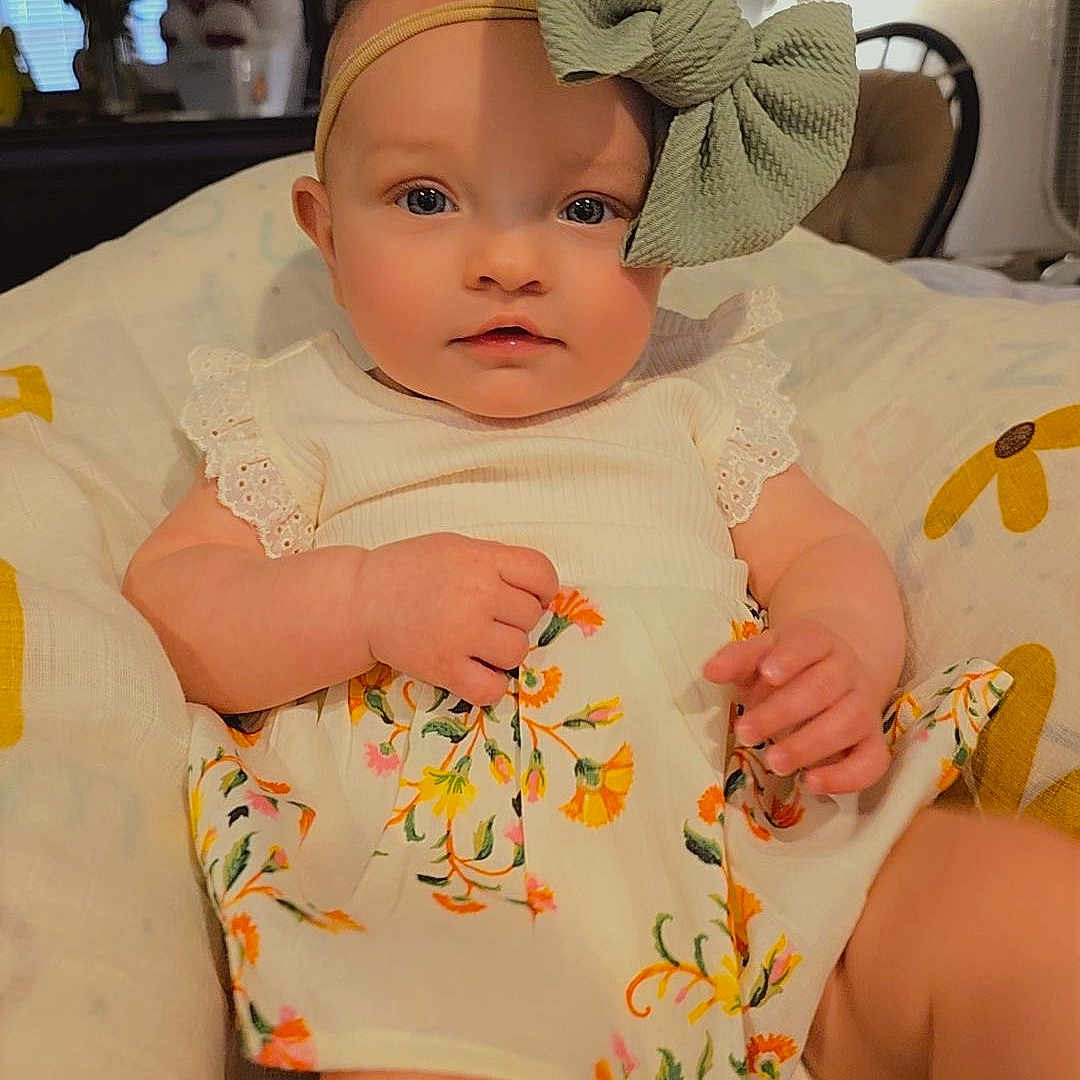 Nellie Jane is registered to the contest to win money with this photo: accessories, baby, bed, bedroom, clothing, couch, cushion, dress, face, furniture, hat, head, homedecor, indoors, person, photography, portrait, room, shorts, sitting