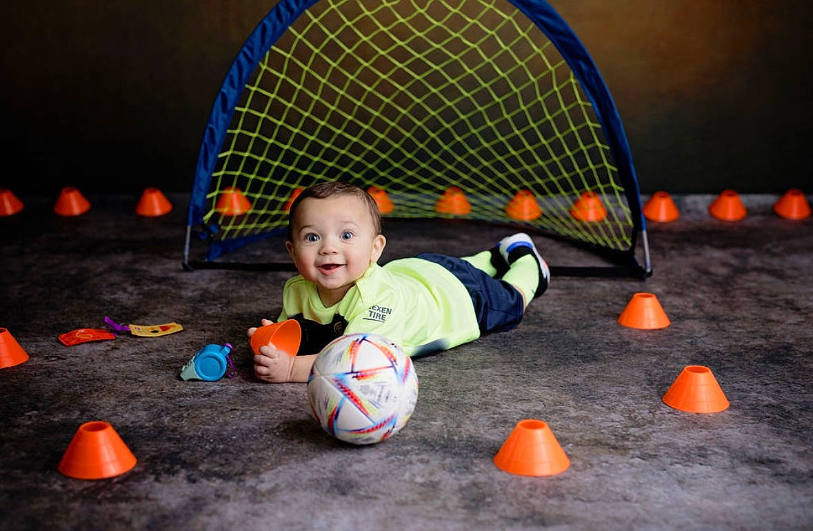 Avery joined the competition — help win amazing prizes! baby, ball, ball_game, child, competition_event, football, fun, games, grass, leisure, orange, person, play, player, recreation, smile, sports, sports_equipment, sports_toy, toddler