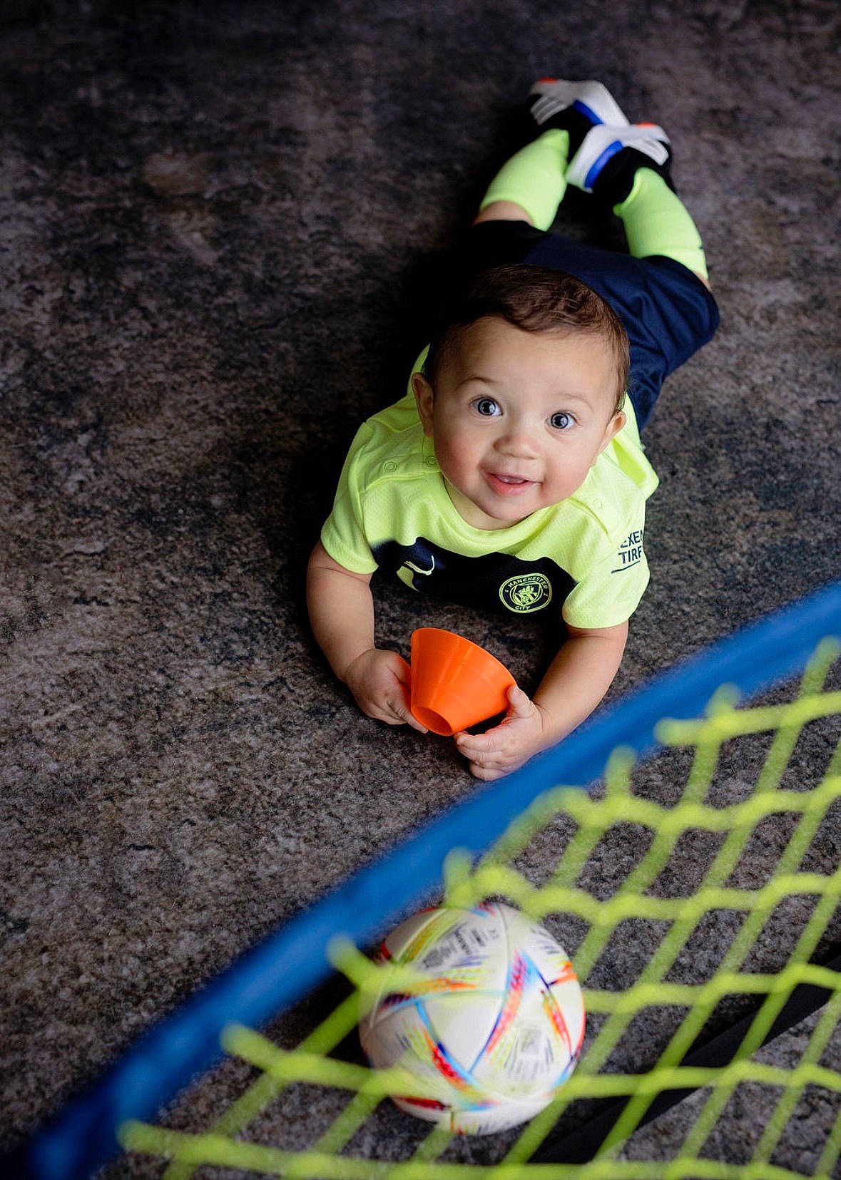 Avery is registered to the contest to win money with this photo: baby, baby_toddler_clothing, ball, flash_photography, football, fun, grass, happy, hat, leisure, net, people_in_nature, person, player, smile, soccer, soccer_ball, sports_equipment, t_shirt, toddler