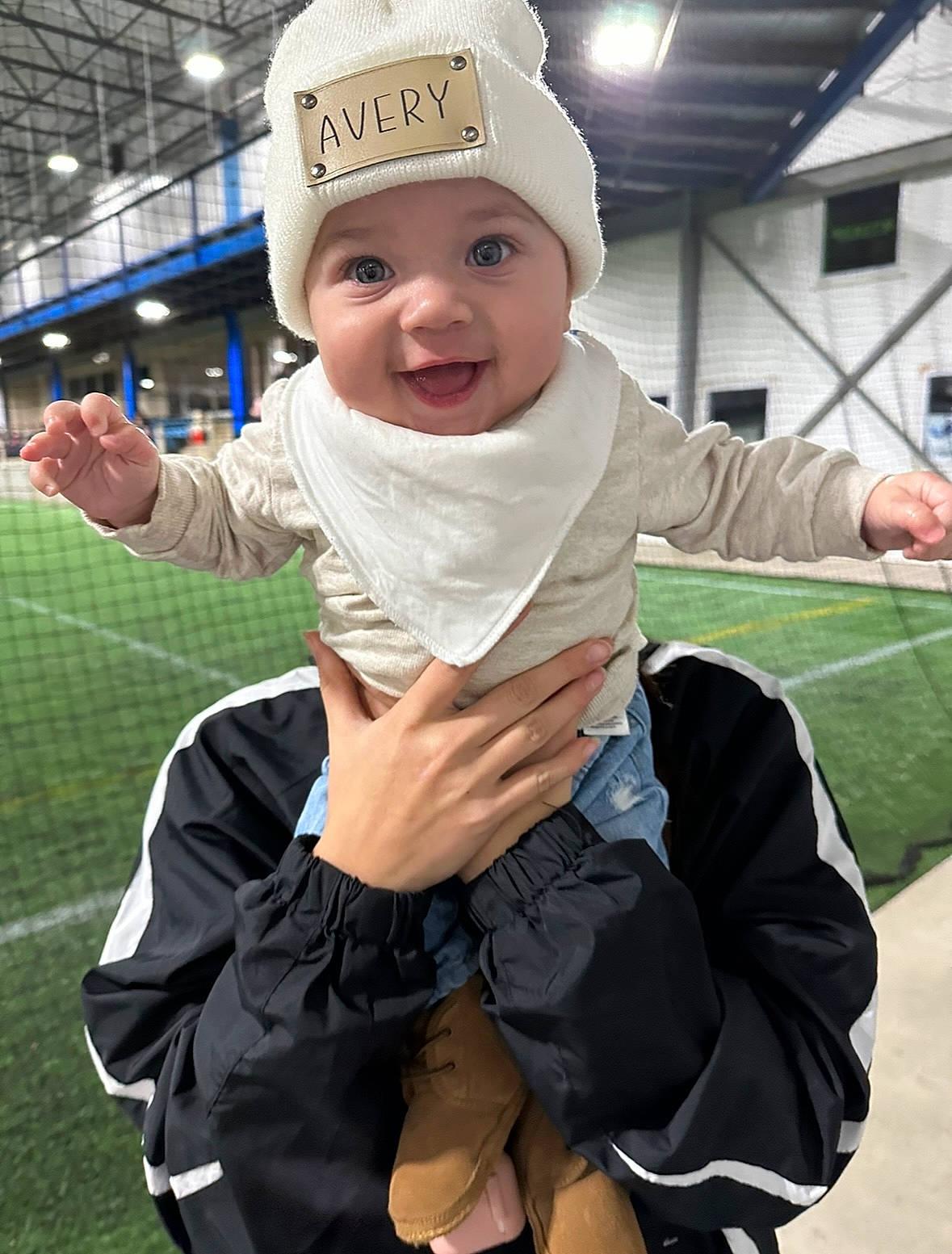 Avery joined the competition — help win amazing prizes! baby, baby_toddler_clothing, baseball_cap, beanie, cap, child, cool, fun, gesture, grass, happy, headgear, headwear, person, personal_protective_equipment, recreation, sitting, sleeve, smile, thumb
