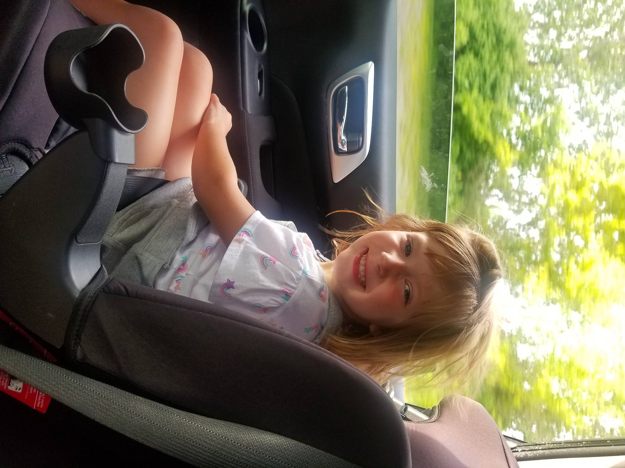 Angel is registered to the contest to win money with this photo: auto_part, automotive_design, automotive_exterior, automotive_tire, bumper, car, car_seat, car_seat_cover, comfort, fun, grass, joy, leisure, mode_of_transport, motor_vehicle, person, personal_luxury_car, smile, tree, trunk