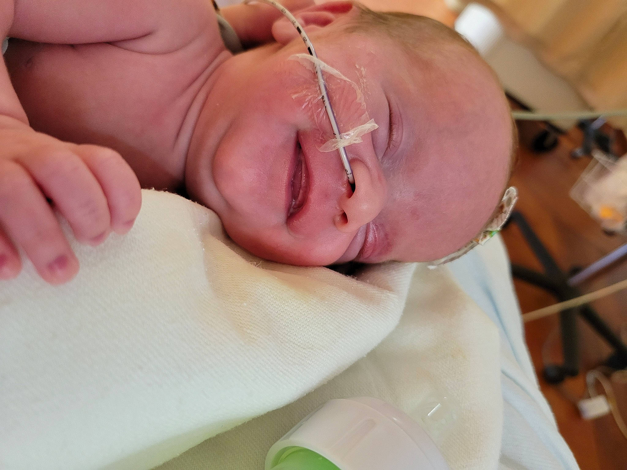 Alexandra is registered to the contest to win money with this photo: baby, baby_toddler_clothing, child, childbirth, comfort, event, finger, gesture, glasses, happy, hat, hospital, nail, patient, person, service, skin, smile, thumb, toddler