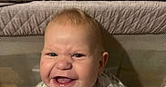 Bradley joined the competition — help win amazing prizes! baby, child, infant, smiling, grinning, portrait, sitting, playpen, indoors, home, bedding, blanket, clothing, drawer, nursery, zipper, patterned_outfit, star_pattern, happy, closeup