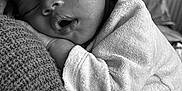 Amaro participe au concours pour gagner de l'argent avec cette photo : baby, sleeping, infant, black_and_white, cozy, blanket, knit, soft, onesie, closeup, peaceful, cute, face, hand, resting, child, portrait, toddler, napping, warm