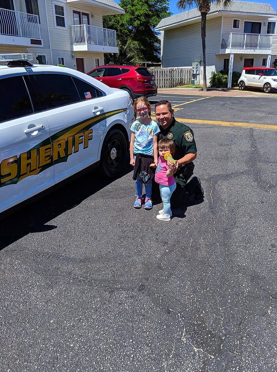 Alexa is registered to the contest to win money with this photo: asphalt, automotive_decal, automotive_exterior, car, family, family_car, full_size_car, jeans, joy, land_vehicle, law_enforcement, limousine, luxury_vehicle, mid_size_car, motor_vehicle, person, police, police_car, sedan, tar