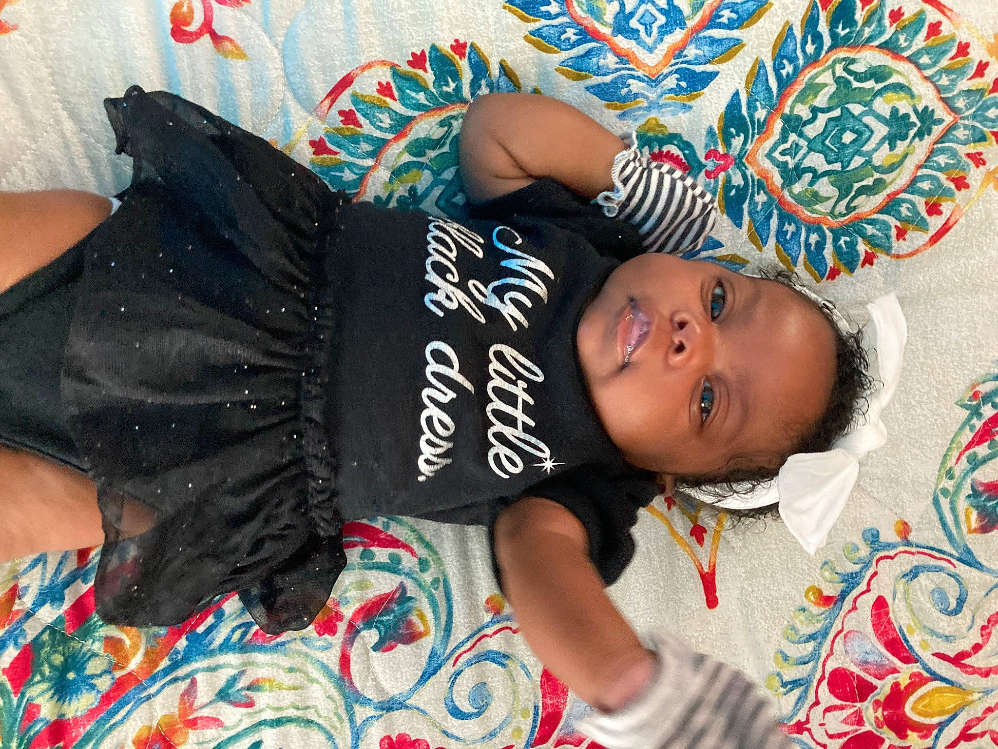 Naomi joined the competition — help win amazing prizes! baby, baby_toddler_clothing, black_hair, child, cool, fashion_accessory, hair, happy, head, headgear, jewellery, pattern, person, room, sitting, skin, sleeve, t_shirt, textile, thigh