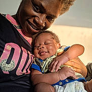 Princeton is registered to the contest to win money with this photo: adult, affection, baby, child, closeup, clothing, face, family, hand, happy, holding, indoor, love, parent, person, portrait, skin, sleeping, smile, warm_light