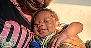 Princeton is registered to the contest to win money with this photo: adult, affection, baby, child, closeup, clothing, face, family, hand, happy, holding, indoor, love, parent, person, portrait, skin, sleeping, smile, warm_light