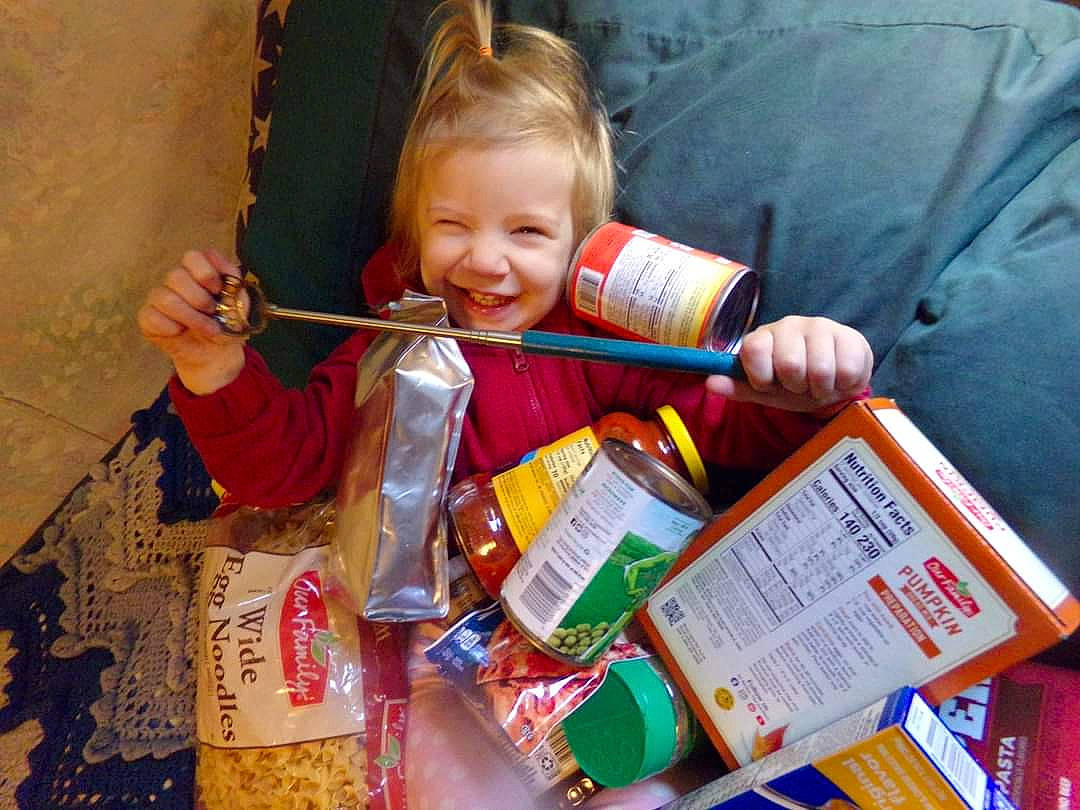 Lily is registered to the contest to win money with this photo: box, child, comfort_food, convenience_food, cuisine, food, fun, happy, ingredient, joy, junk_food, meal, natural_foods, packaging_and_labeling, packing_materials, person, plastic, smile, snack, toddler