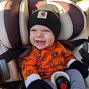Chandler joined the competition — help win amazing prizes! baby, child, car_seat, beanie, mittens, sweater, pumpkin_pattern, smile, happy, clothing, seatbelt, infant, cute, warm_clothing, autumn, indoor, person, headwear, portrait, cozy