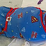 Jace joined the competition — help win amazing prizes! baby, infant, swaddle, superman, blue_clothing, bed, hospital, nasal_tube, medical, blanket, pacifier, newborn, cute, lying_down, person, child, healthcare, face, head, expression