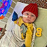 Jace joined the competition — help win amazing prizes! baby, crib, blanket, mittens, red_hat, yellow_onesie, pacifier, toy, blue_mittens, striped_blanket, pillow, cartoon_character, infant, bed, child, face, sleepwear, soft_toys, cute, indoors
