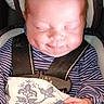 Joseph is registered to the contest to win money with this photo: baby, infant, child, sleeping, smiling, car_seat, harness, blanket, striped_clothing, long_sleeves, portrait, close_up, indoors, seated, face, hands, red_hair, cozy, peaceful, photograph