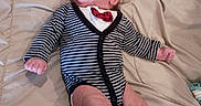 Joseph joined the competition — help win amazing prizes! baby, newborn, child, infant, portrait, lying_down, bed, blanket, striped_clothing, cardigan, bow_tie, pacifier, face, eyes_open, indoor, bedroom, relaxed, cute, photography, furniture